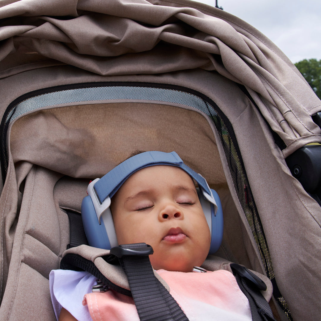 Baby sleeping while wearing muffy baby in denim-blue