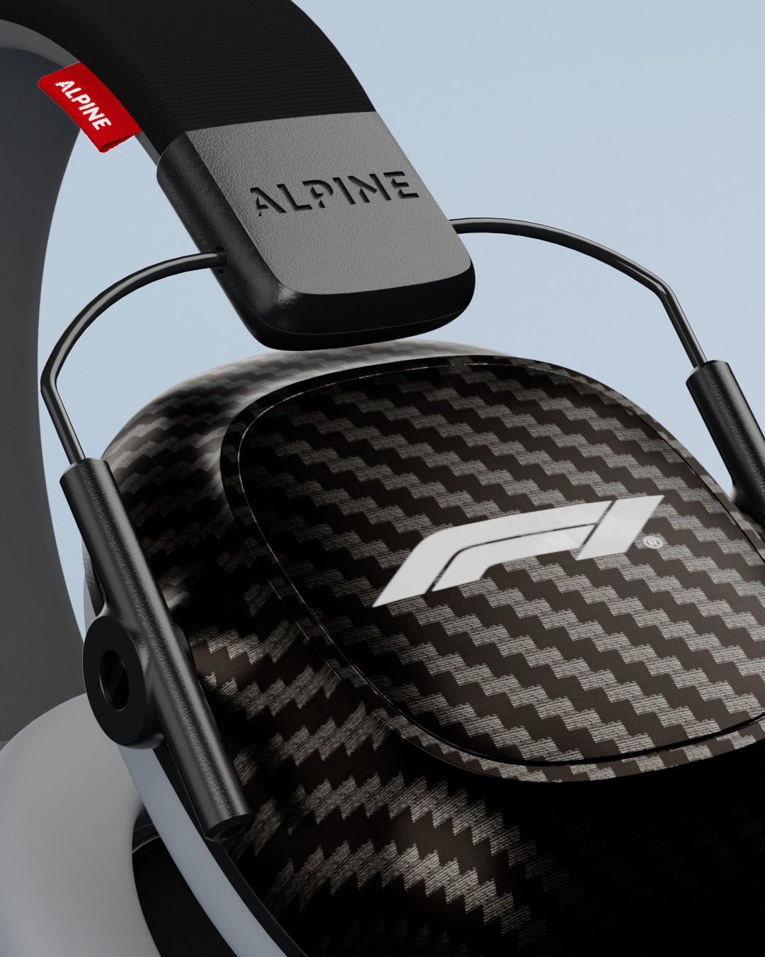 Close-up of a carbon-look ear cup with white F1 logo and Alpine-branded headband on Alpine Formula 1® earmuffs